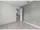 An empty room showing an open doorway leading into a kitchen area, with a tiled floor at 5112 Odin St, Spring Hill, FL 34608