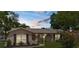 Charming home with a stucco exterior, arched entryways, and lush landscaping at dusk at 5112 Odin St, Spring Hill, FL 34608