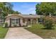 Charming home with a stucco exterior, arched entryways, and lush landscaping at 5112 Odin St, Spring Hill, FL 34608