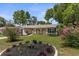Well-maintained home with a manicured lawn and colorful flower beds at 5112 Odin St, Spring Hill, FL 34608