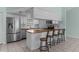 Modern kitchen with white cabinets, subway tile backsplash, stainless steel appliances, and a breakfast bar at 5112 Odin St, Spring Hill, FL 34608