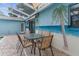 Outdoor patio with table and chairs and a palm tree beach-themed mural at 5112 Odin St, Spring Hill, FL 34608