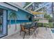 Outdoor dining area on a brick-paver patio, adjacent to a pool and a covered lanai at 5112 Odin St, Spring Hill, FL 34608