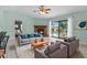 Cozy living room with a fireplace, comfortable seating, and a view of the pool area at 5112 Odin St, Spring Hill, FL 34608