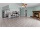 Open-concept living area with tile flooring, a breakfast bar, stone fireplace, and modern lighting at 5112 Odin St, Spring Hill, FL 34608