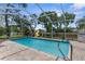 Relaxing screened pool with brick pavers, a play set, and lush landscaping at 5112 Odin St, Spring Hill, FL 34608