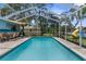Inviting screened-in pool with brick-paver decking, outdoor seating area, and fun backyard features at 5112 Odin St, Spring Hill, FL 34608
