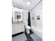 Bathroom features black and white color scheme, tiled shower, updated vanity, and framed mirror at 5730 Imperial Ky, Tampa, FL 33615