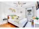Stylish bedroom boasts hardwood floors, decorative wall art, and a cozy bed with colorful accent pillows at 5730 Imperial Ky, Tampa, FL 33615