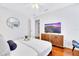 Charming bedroom features wood floors, mounted television, and comfortable layout at 5730 Imperial Ky, Tampa, FL 33615