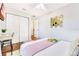 Bedroom with wooden floors, TV, a desk, and a double closet offer ample storage and comfort at 5730 Imperial Ky, Tampa, FL 33615