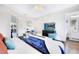 Bedroom features sleek furniture, a mounted TV, and access to the bathroom and seating area at 5730 Imperial Ky, Tampa, FL 33615