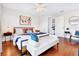 Bedroom featuring stylish decor, wood flooring, a ceiling fan and a luxurious upholstered bench at 5730 Imperial Ky, Tampa, FL 33615
