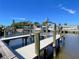 Waterfront home featuring a private dock with boat lift providing direct access to the open water, perfect for boating enthusiasts at 5730 Imperial Ky, Tampa, FL 33615