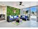 Stylish patio featuring a comfortable outdoor sectional, bright tropical rug, and a vibrant green wall for added privacy at 5730 Imperial Ky, Tampa, FL 33615