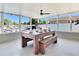 Bright enclosed patio with abundant natural light, a large dining table with bench seating, and ample space for entertaining at 5730 Imperial Ky, Tampa, FL 33615