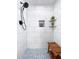 Modern shower with sleek marble tiling, a built-in niche, and a stylish bench for a luxurious experience at 5730 Imperial Ky, Tampa, FL 33615