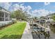 Beautiful backyard view showcasing a well-maintained lawn, canal, and personal boat dock at 650 Geneva Pl, Tampa, FL 33606