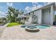 Exterior view of home featuring a pool, spa, screened lanai and waterway at 650 Geneva Pl, Tampa, FL 33606