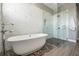 Luxurious bathroom with freestanding tub and glass-enclosed shower featuring river rock base at 650 Geneva Pl, Tampa, FL 33606