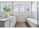 Luxurious bathroom with double vanity, soaking tub, marble tile and lots of natural light at 650 Geneva Pl, Tampa, FL 33606