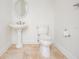 Bathroom with a pedestal sink and toilet at 650 Geneva Pl, Tampa, FL 33606