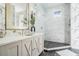 Elegant bathroom with marble shower, modern vanity, and designer wallpaper at 650 Geneva Pl, Tampa, FL 33606