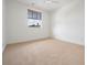 Bright bedroom with neutral carpet, ceiling fan, and a window offering natural light at 650 Geneva Pl, Tampa, FL 33606