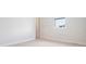 Minimalist bedroom featuring light carpet, white walls, and a window for natural lighting at 650 Geneva Pl, Tampa, FL 33606
