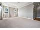 Open bedroom with neutral carpet, abundant natural light, and tray ceiling with recessed lighting at 650 Geneva Pl, Tampa, FL 33606