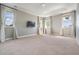Sunlit bedroom with plush carpet, recessed lighting, and multiple windows with draperies at 650 Geneva Pl, Tampa, FL 33606