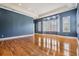 Large bonus room with hardwood floors, crown molding, and bay window with shutters at 650 Geneva Pl, Tampa, FL 33606