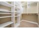 Spacious walk-in closet featuring ample shelving and hanging rods for organized storage solutions at 650 Geneva Pl, Tampa, FL 33606