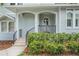 Charming front porch with arched entry and decorative landscaping at 650 Geneva Pl, Tampa, FL 33606