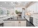 Open concept kitchen with white cabinets, granite countertops, an island, and modern lighting at 650 Geneva Pl, Tampa, FL 33606
