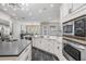 Modern kitchen with stainless steel appliances, custom cabinets, granite countertops, and modern lighting at 650 Geneva Pl, Tampa, FL 33606