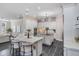 Spacious kitchen with white cabinets, stainless steel appliances, granite countertops, and barstool seating at 650 Geneva Pl, Tampa, FL 33606