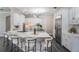Open kitchen with white cabinets, granite countertops, stainless appliances, and barstool seating at 650 Geneva Pl, Tampa, FL 33606