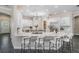 Bright and airy kitchen featuring white cabinets, an oversized island, and barstool seating at 650 Geneva Pl, Tampa, FL 33606
