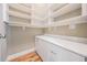 Pantry with ample shelving, white cabinets, and hardwood floors at 650 Geneva Pl, Tampa, FL 33606