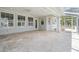 Expansive screened patio with neutral stone flooring and views of the backyard at 650 Geneva Pl, Tampa, FL 33606