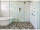 Spacious shower with river rock base, glass doors, and white subway tile surround at 650 Geneva Pl, Tampa, FL 33606