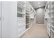 Spacious walk-in closet with custom shelving, drawers, and ample hanging space at 650 Geneva Pl, Tampa, FL 33606