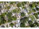 Neighborhood aerial view showing the house surrounded by lush greenery and residential streets at 716 35Th W St, Bradenton, FL 34205