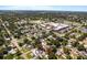 An aerial view of a neighborhood featuring a home with mature trees and a nearby school at 716 35Th W St, Bradenton, FL 34205