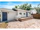 This backyard has a brick patio, wooden deck, and white exterior of a house at 716 35Th W St, Bradenton, FL 34205