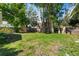 A tranquil backyard with mature trees provides a serene setting and shade at 716 35Th W St, Bradenton, FL 34205