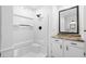 Bathroom featuring a shower, mirror, and brown granite countertop sink and wood floor at 716 35Th W St, Bradenton, FL 34205