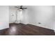 A spacious room featuring dark wood flooring and a ceiling fan with white walls at 716 35Th W St, Bradenton, FL 34205