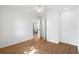 Bedroom with hardwood floors, fresh paint and a view into the kitchen at 716 35Th W St, Bradenton, FL 34205